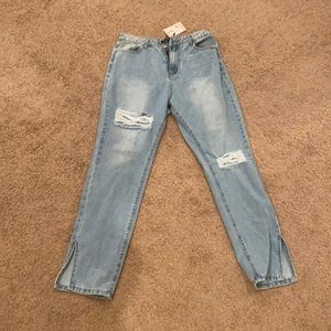 Ripped jeans with slit at the bottom.